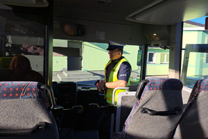 Policjant rozmawia z kierowcą autobusu
